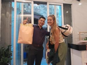 a man and a woman holding a shopping bag at Hanoi Holiday Hotel in Hanoi