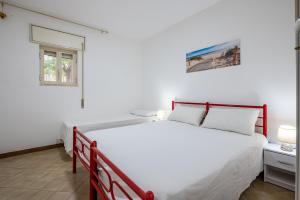 a bedroom with a large white bed and a window at Bagnara Due in Lizzano