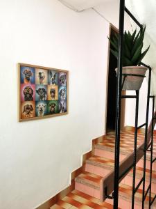 a stairway with a framed picture on the wall at Guesthouse "Slavkova" in Sozopol