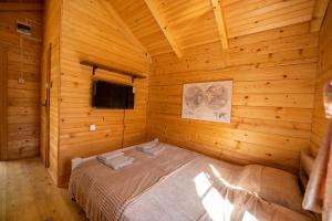 a bedroom with a bed in a wooden cabin at Via river in Podgorica