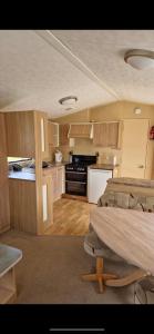 a kitchen with two beds and a table in a room at Skegness Holidays at Haven in Skegness
