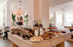 a buffet of pastries and desserts on a table at Portomar Apartments in Portocolom