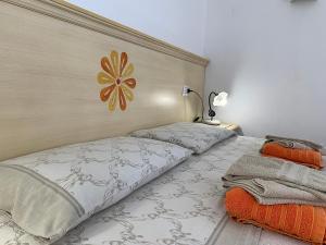 a bedroom with two beds and a flower on the wall at Vistamare in Orosei