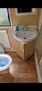 a bathroom with a sink and a toilet at Skegness Holidays at Haven in Skegness