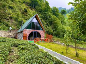 a small house on a hill in a field at Moon River Bungalow in Ayder Yaylasi