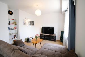 a living room with a couch and a table at Sunny Apartment for 2 in Murter
