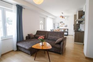 a living room with a couch and a table at Sunny Apartment for 2 in Murter