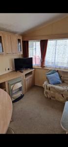 a small living room with a couch and a television at Skegness Holidays at Haven in Skegness