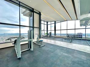 a gym with windows and a view of the city at Twin Tower Residence Johor Bahru by Stayrene in Johor Bahru