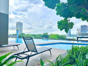 a chair sitting next to a swimming pool at Twin Tower Residence Johor Bahru by Stayrene in Johor Bahru