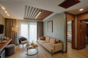 a living room with a couch and a table at Kazdağları Allia Thermal Health & Spa in Edremit
