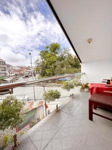 a balcony with a red couch and a view of a city at White Horse Dalat Hotel in Da Lat