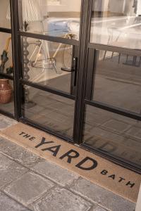 a sign that says the kitchen written on a glass door at The Yard in Bath Hotel in Bath