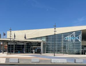 a large glass building with a sign on it at Villa Hélios in Canet-en-Roussillon