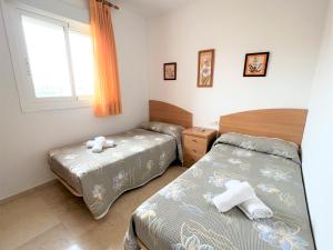 Ein Bett oder Betten in einem Zimmer der Unterkunft Gemelos 22-3-12