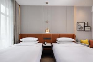 Ένα ή περισσότερα κρεβάτια σε δωμάτιο στο Home2 Suites By Hilton Foshan Jiujiang