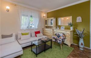 a living room with a couch and a table at Nice Home In Susanj With Wifi And 3 Bedrooms in Sušanj