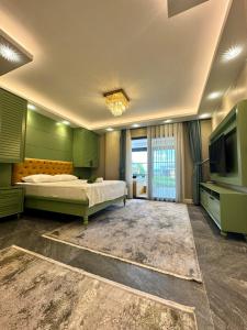 a bedroom with a bed and a flat screen tv at SAPANCA ALHARRAN VILLA in Sapanca
