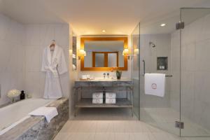 a bathroom with a tub and a sink and a shower at lebua at State Tower in Bangkok