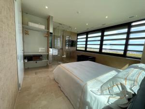 a bedroom with a large bed and a shower at Foresteria Castorani in Alanno