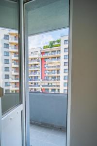 a view of a building from a window at Refreshingly Chic: Newly Renovated 2BR Apartment in Bucharest