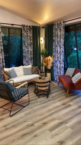 a living room with a couch and a table at Le Mont Brouilly in Quincié-en-Beaujolais