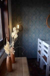 einen Tisch mit zwei Vasen mit Blumen in einem Zimmer in der Unterkunft Casa Yacumenza in Montevideo
