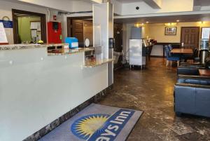 a hotel lobby with a bar and a kitchen at Days Inn by Wyndham Denver Downtown in Denver