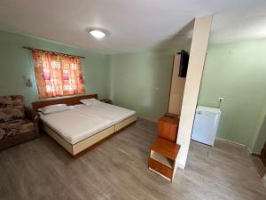 a bedroom with a bed and a television in it at Zora Camping - Bungalows in Obzor