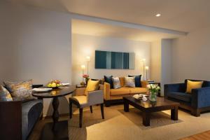 a living room with couches and a table at lebua at State Tower in Bangkok
