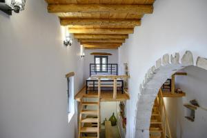 an attic room with an archway and wooden ceilings at Nomas Home Imbros with Private Pool in Hora Sfakion