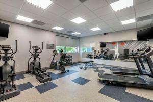 a gym with treadmills and cardio equipment in a room at GLō Best Western Savannah-Gateway I-95 in Savannah