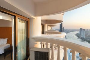 a balcony of a building with a view of a river at lebua at State Tower in Bangkok