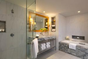 a bathroom with a shower and a sink and a tub at lebua at State Tower in Bangkok
