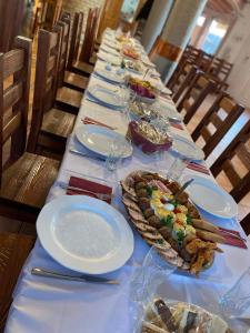 a long table with plates of food on it at Chillout House in Sótony