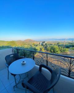 a table and chairs on a balcony with a view at Handra Apartment Seaview in Kos