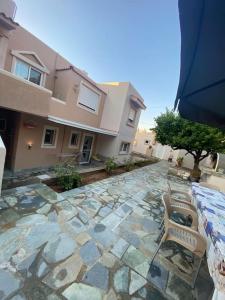 a stone patio with two chairs and a building at Handra Apartment Seaview in Kos