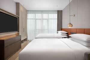 Ένα ή περισσότερα κρεβάτια σε δωμάτιο στο Home2 Suites By Hilton Foshan Jiujiang