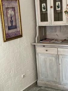 a room with a white cabinet and a picture on the wall at Domek Masuria in Orzysz +32 photos