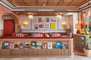 a room with a bookstore with books on a counter at Hotel de Silhouette in Biarritz