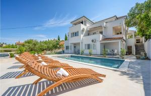 a villa with a swimming pool and a house at Amazing Apartment In Murter With Wifi in Murter
