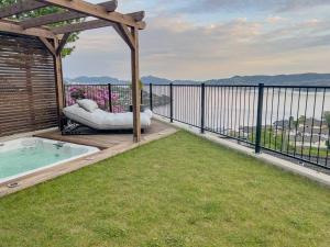 a gazebo with a hot tub on a balcony at Sjøutsikt, jacuzzi og solfylt in Bergen