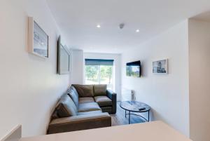 a living room with a couch and a table at Liverpool Short Stay Apartments in Liverpool