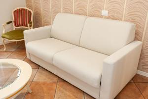 Sofá blanco en una habitación con mesa en Residenza Catullo - Apartments, en Verona