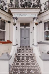 a hotel entrance with a checkered floor in front of a door at Sherwood Hotel in Margate