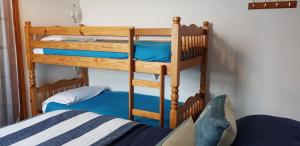 two bunk beds in a room with a bed at Rose Court Holiday Apartments in Torquay