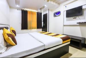 a bedroom with a bed and a television in it at Venus Hotel 5 Minute Walking Distance from Dargah in Ajmer