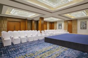 a conference room with a blue table and white chairs at Fairfield by Marriott Goa Calangute in Calangute