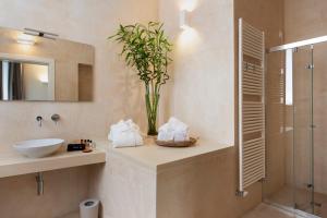 a bathroom with a sink and a glass shower at I Bastioni San Domenico - Boutique Hotel in Gallipoli