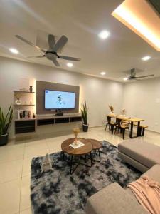 a living room with a couch and a tv at Stylish Cozy House Near Ipoh Lost World Tambun in Kampong Batu Lapan